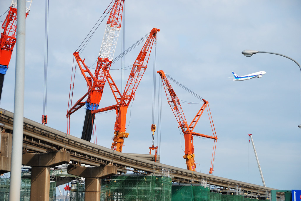 "Cranes by A-Runway of Haneda Airport" by ykanazawa1999 is licensed under CC BY-NC-SA 2.0